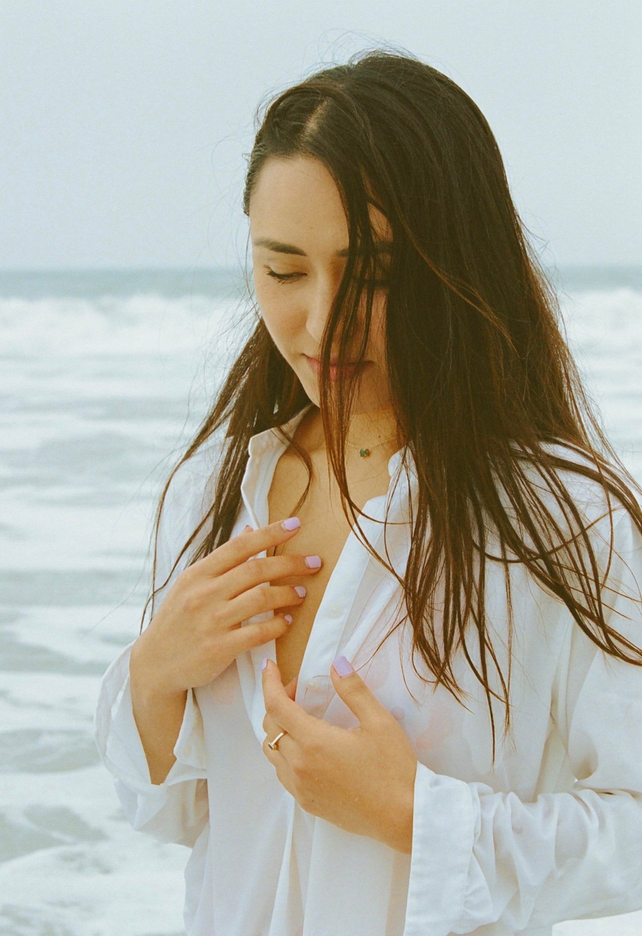 Akane Millan photographed in a white shirt by the ocean